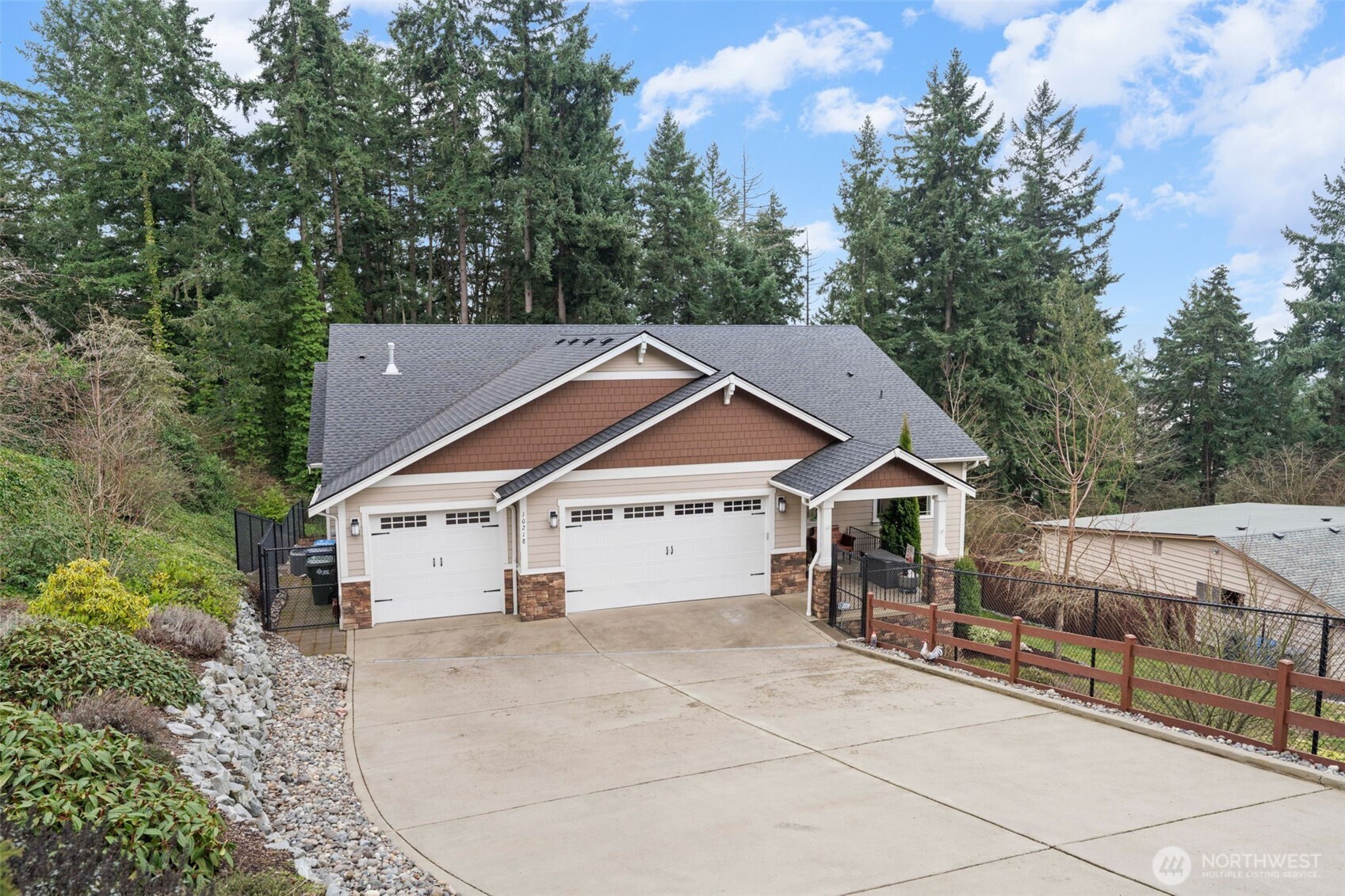 10218 45th Street East Edgewood, WA 98372 - Photo 2 of 34 a house with trees in the background