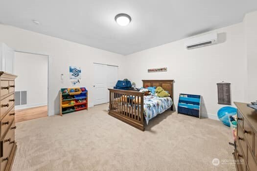 10218 45th Street East Edgewood, WA 98372 - Photo 23 of 34 a bedroom with furniture and a baby crib