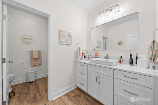 10218 45th Street East Edgewood, WA 98372 - Photo 24 of 34 a en suite bathroom with a granite countertop sink and a mirror