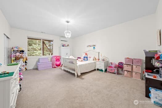 10218 45th Street East Edgewood, WA 98372 - Photo 25 of 34 a bedroom with furniture a bed and a window