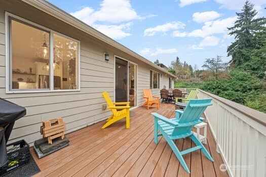 10218 45th Street East Edgewood, WA 98372 - Photo 26 of 34 a balcony with wooden floor and outdoor seating