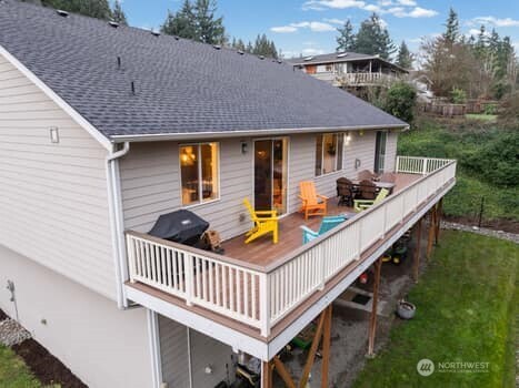 10218 45th Street East Edgewood, WA 98372 - Photo 27 of 34 a view of a patio with a chairs and table in the patio