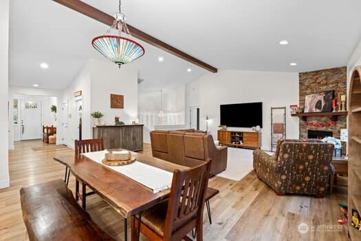 10218 45th Street East Edgewood, WA 98372 - Photo 10 of 34 a living room with furniture a flat screen tv and kitchen view