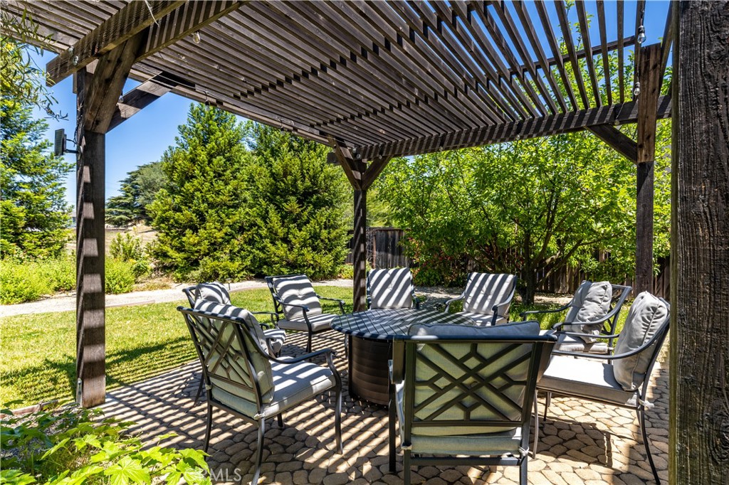 669 Red Cloud Road Paso Robles, CA 93446 - Photo 44 of 61 a view of a patio with table and chairs potted plants with wooden floor and fence