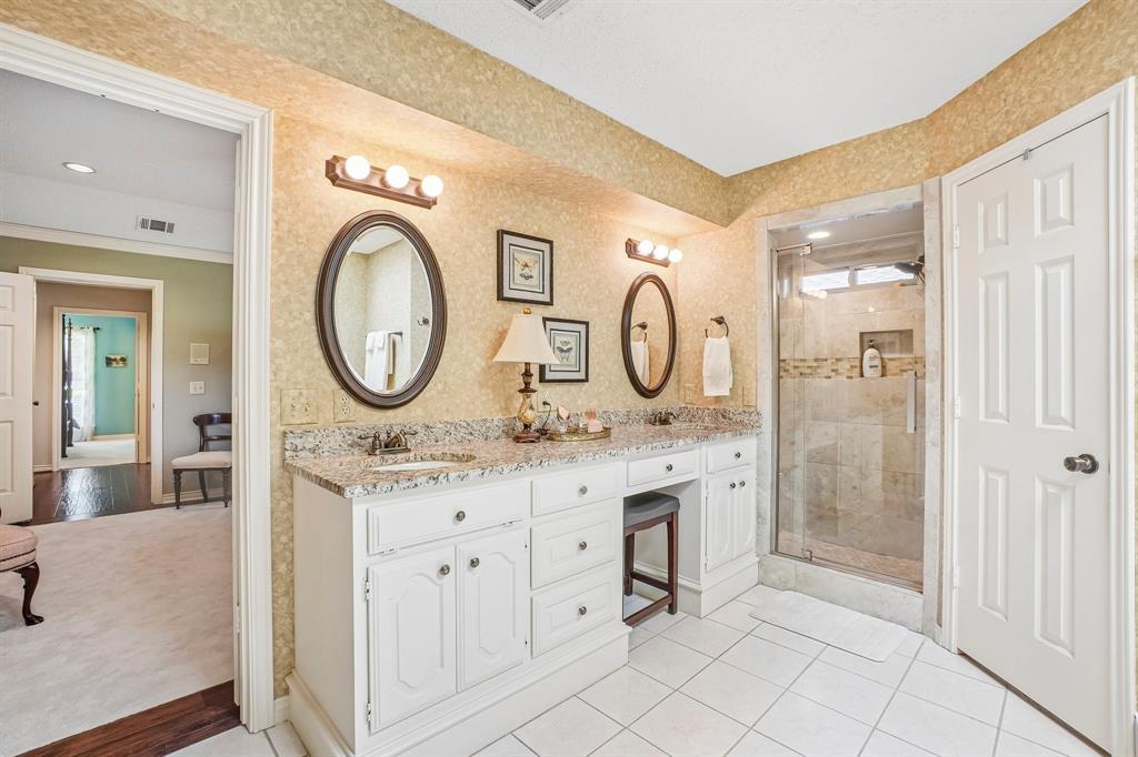 12929 Jasoncrest Trail Dallas, TX 75243 - Photo 24 of 38 Dual vanity with granite countertops, white cabinetry, and a dedicated makeup area