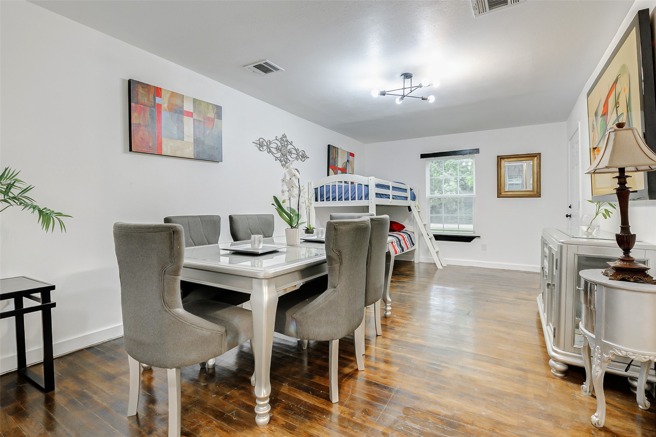 706 Beaumont Street Anahuac, TX 77514 - Photo 12 of 39 a view of a dining room with furniture and wooden floor