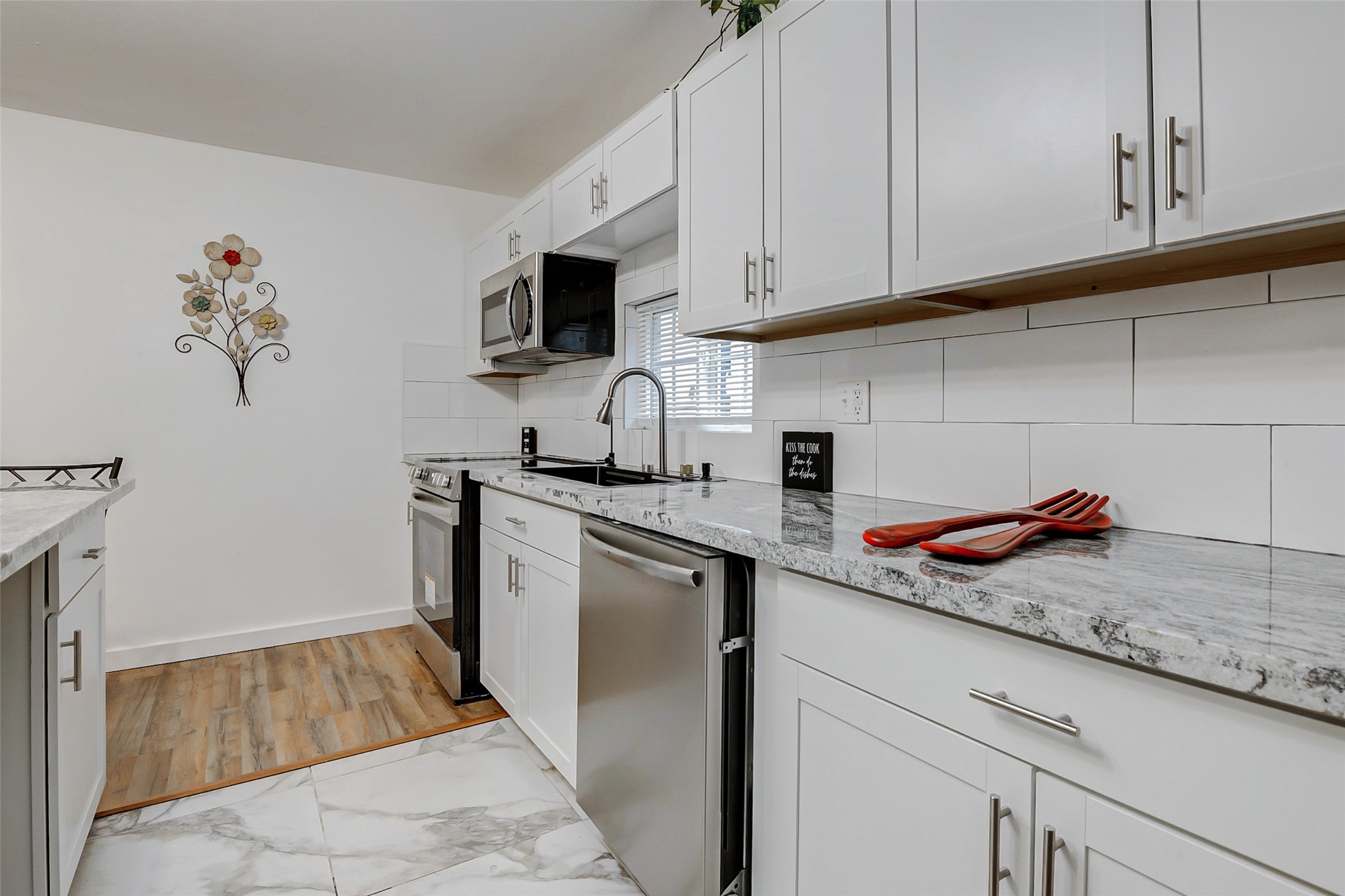 706 Beaumont Street Anahuac, TX 77514 - Photo 14 of 39 a kitchen with stainless steel appliances granite countertop a sink and a microwave