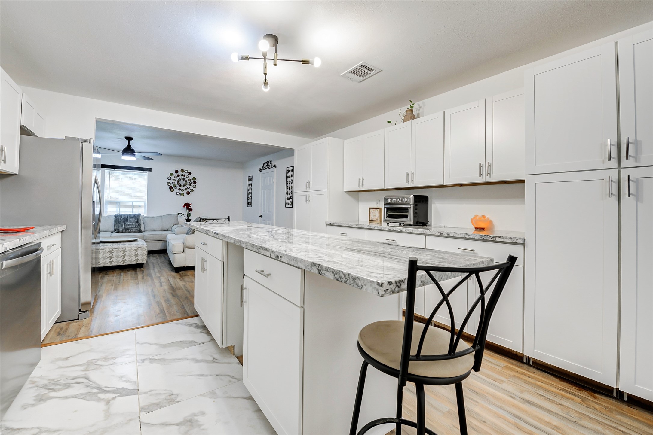 706 Beaumont Street Anahuac, TX 77514 - Photo 16 of 39 a kitchen with a refrigerator a sink and cabinets