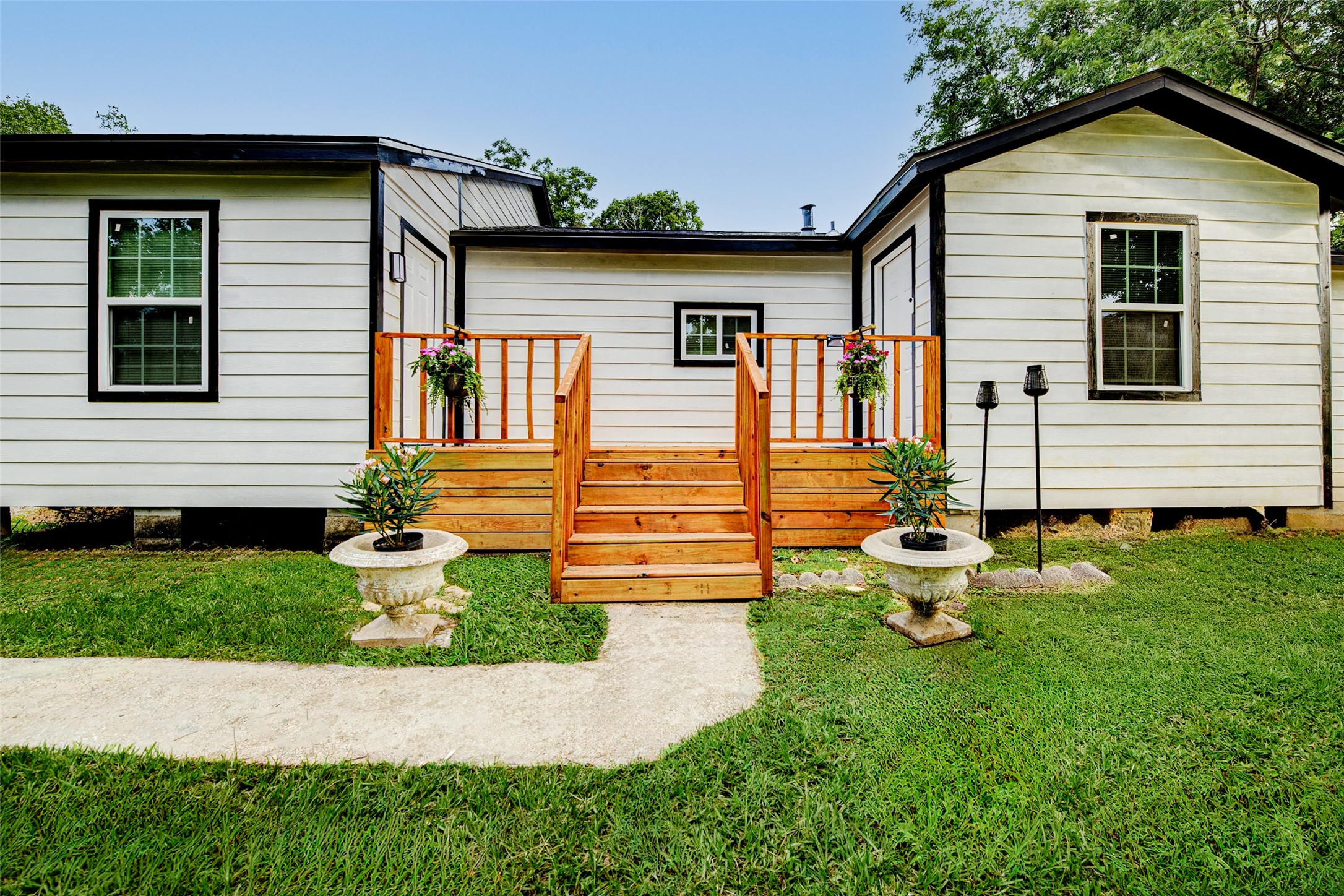 706 Beaumont Street Anahuac, TX 77514 - Photo 3 of 39 a front view of a house with garden