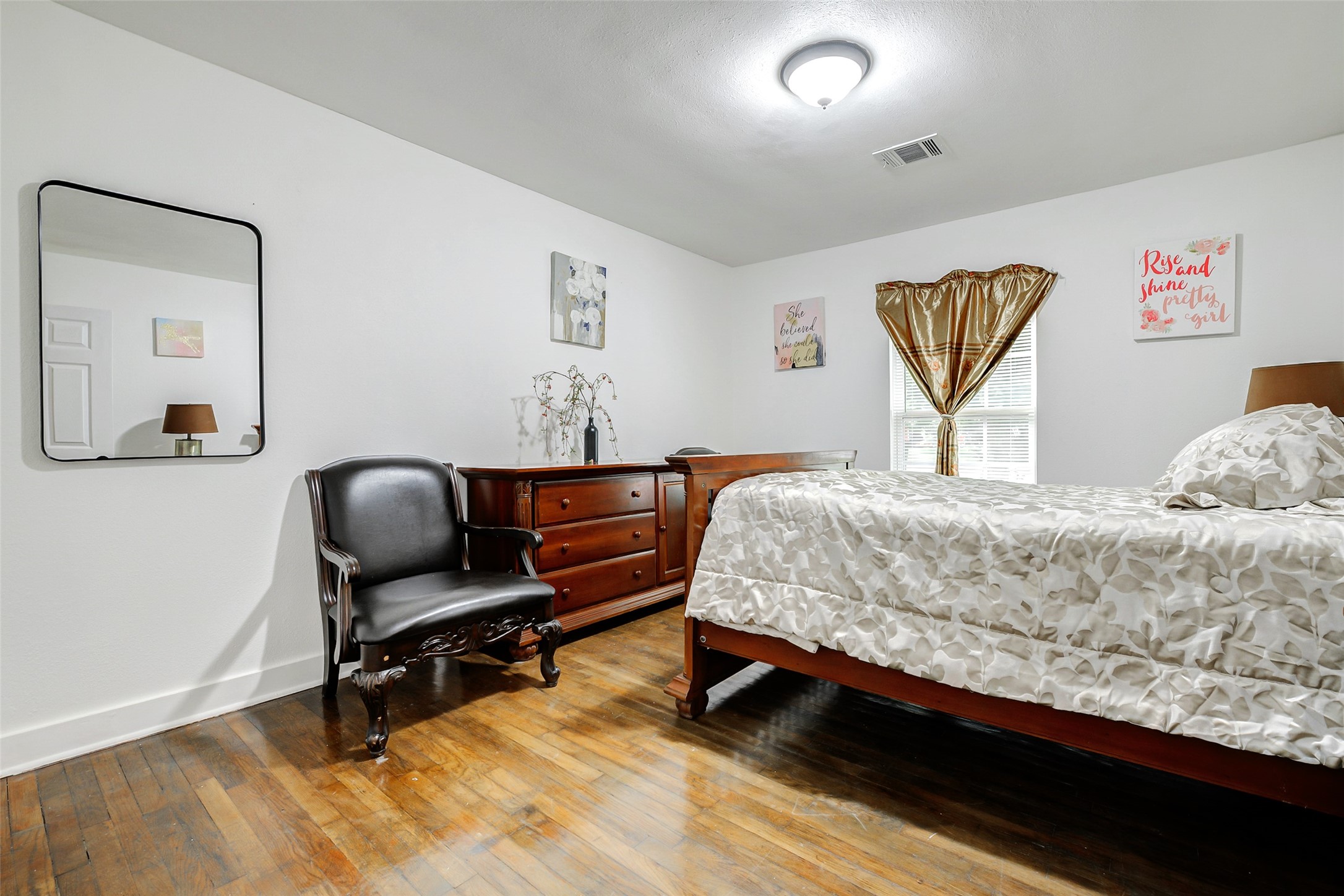 706 Beaumont Street Anahuac, TX 77514 - Photo 31 of 39 a bedroom with a bed and a desk