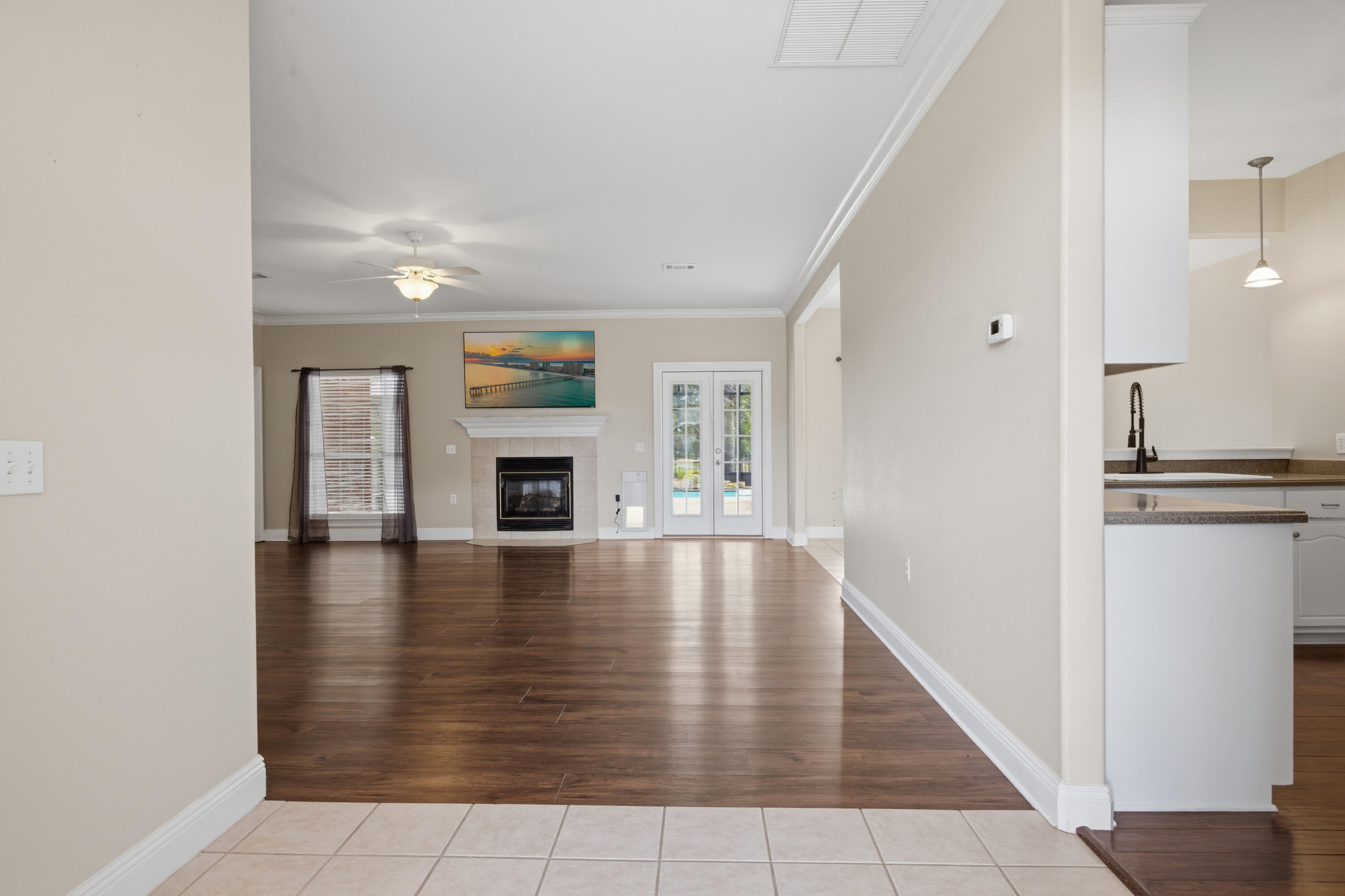 51 Tournament Lane Freeport, FL 32439 - Photo 17 of 71 an empty room with wooden floor and fireplace