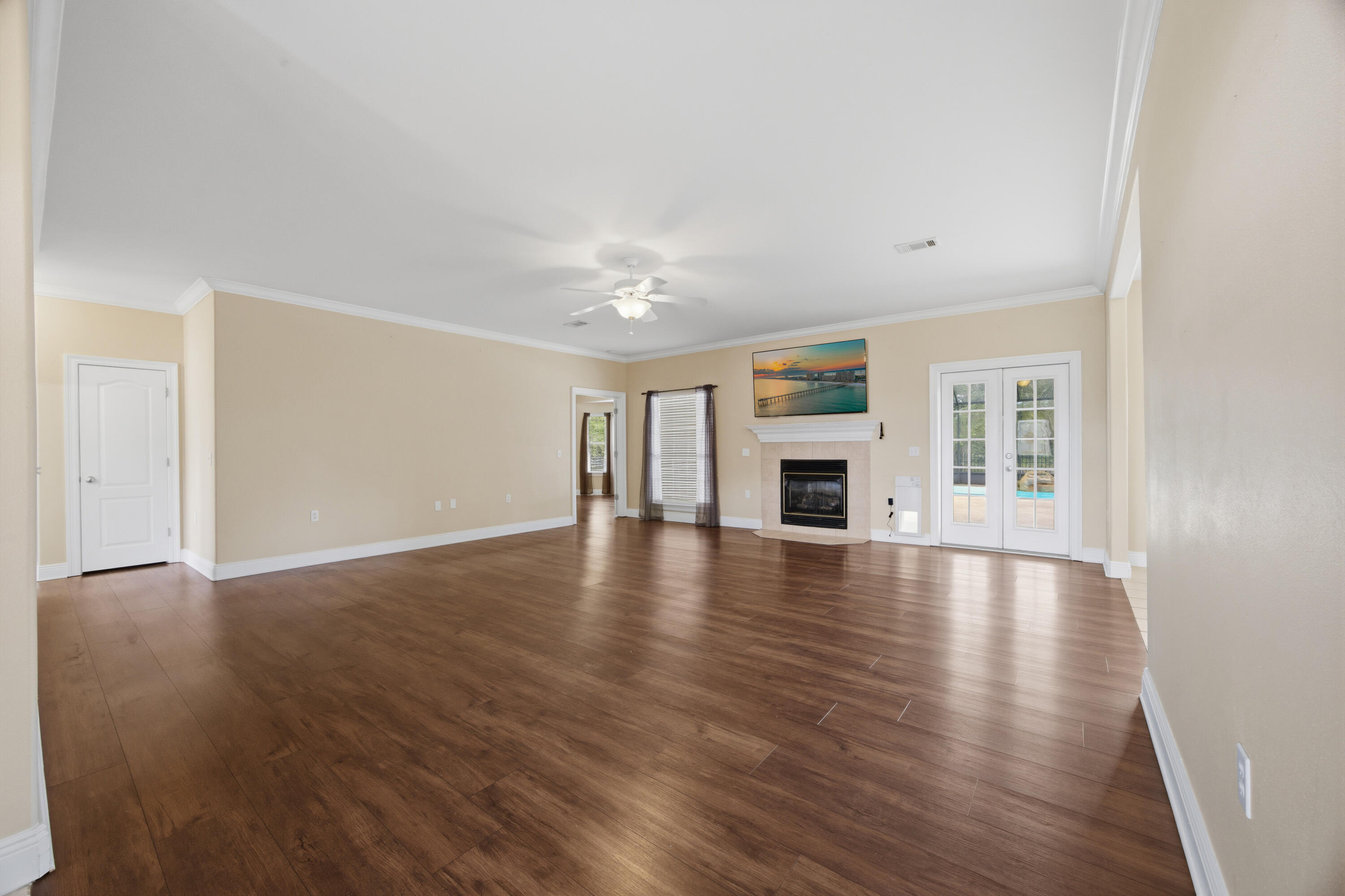 51 Tournament Lane Freeport, FL 32439 - Photo 19 of 71 an empty room with wooden floor fireplace and windows