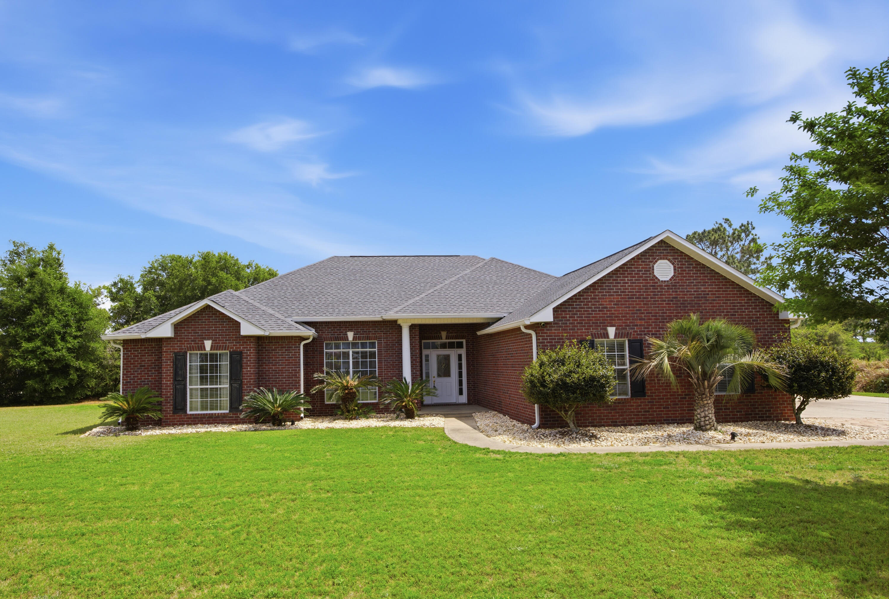 51 Tournament Lane Freeport, FL 32439 - Photo 2 of 71 a front view of a house with a garden