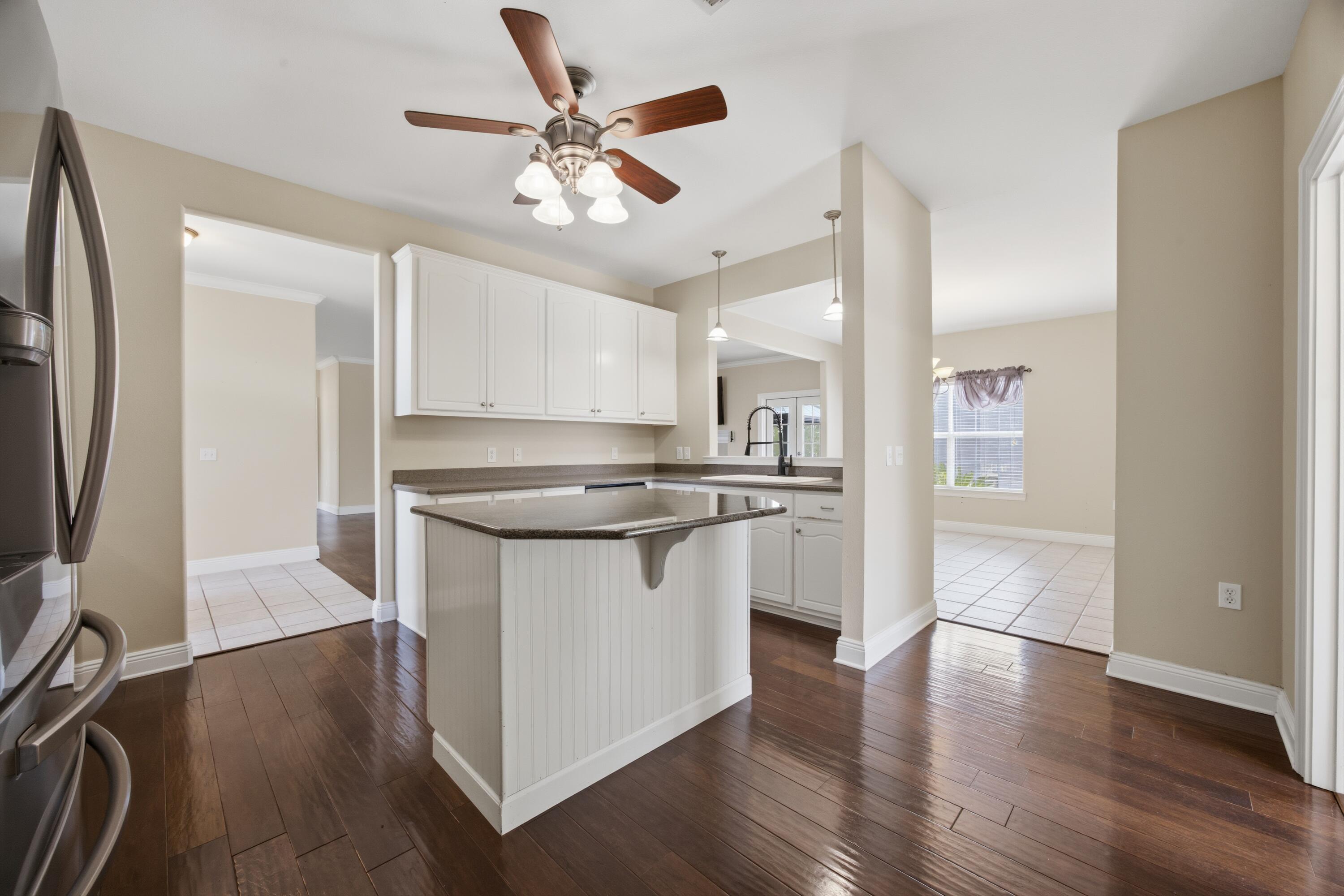 51 Tournament Lane Freeport, FL 32439 - Photo 26 of 71 a kitchen with stainless steel appliances granite countertop a refrigerator a stove and a sink