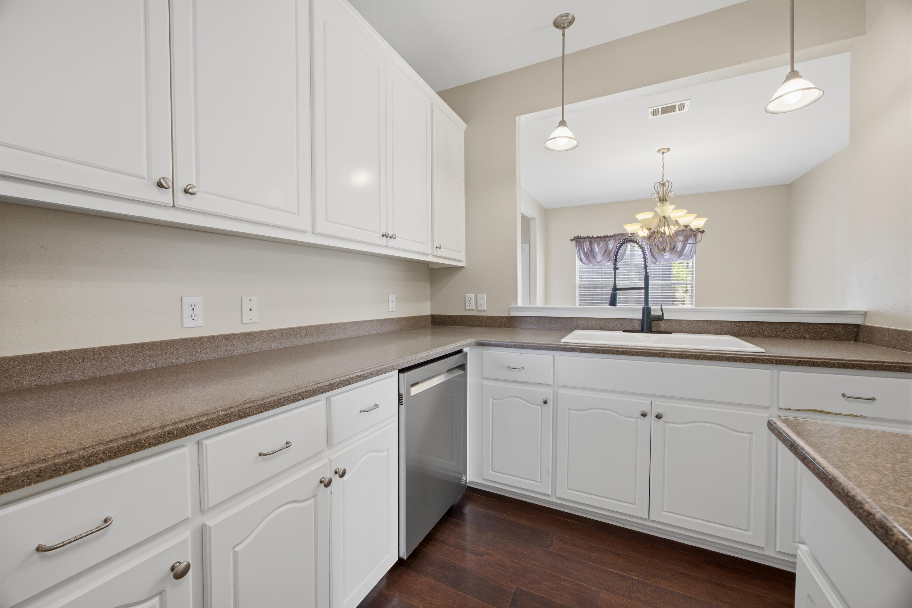 51 Tournament Lane Freeport, FL 32439 - Photo 28 of 71 a kitchen with white cabinets and sink