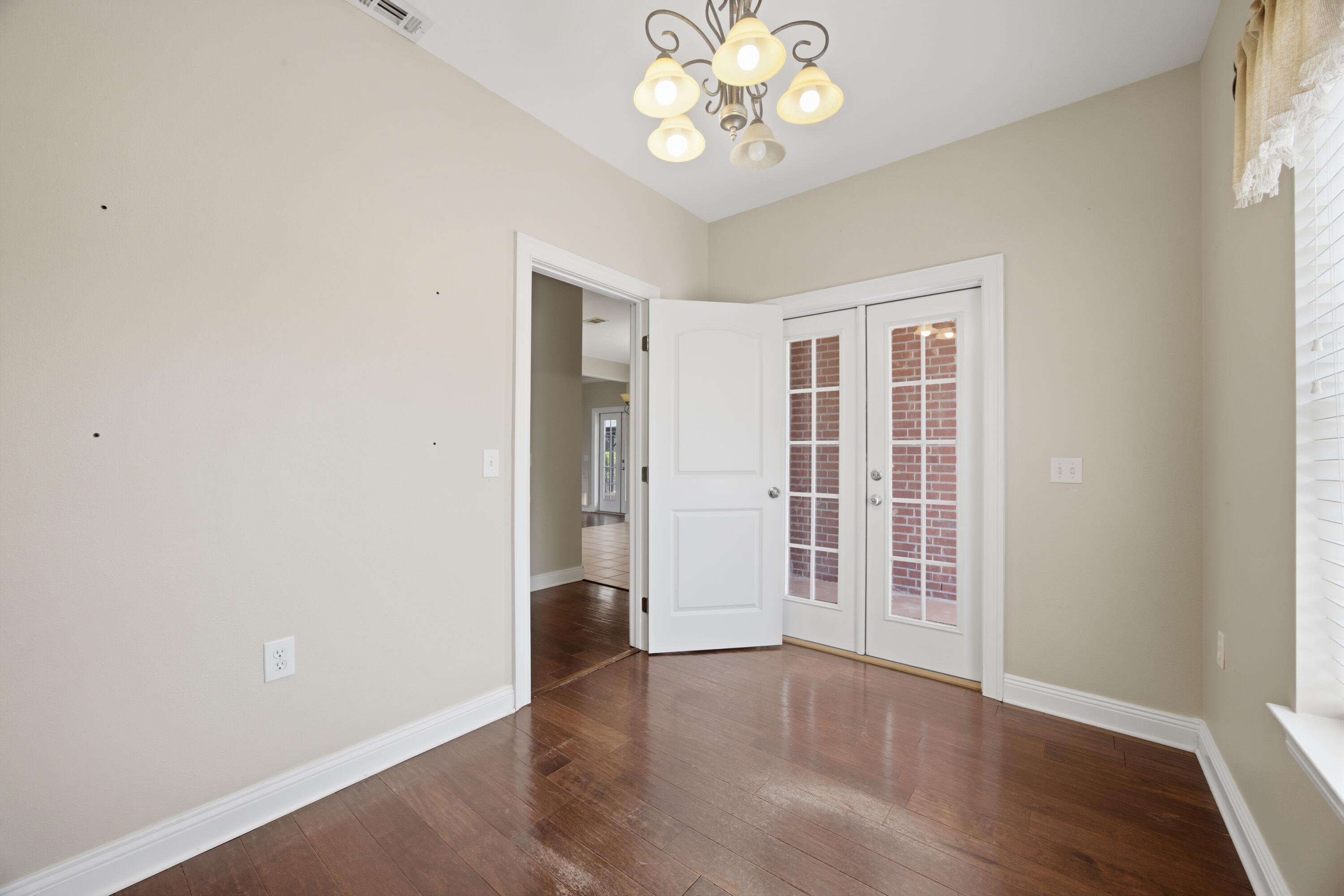 51 Tournament Lane Freeport, FL 32439 - Photo 33 of 71 an empty room with wooden floor and windows