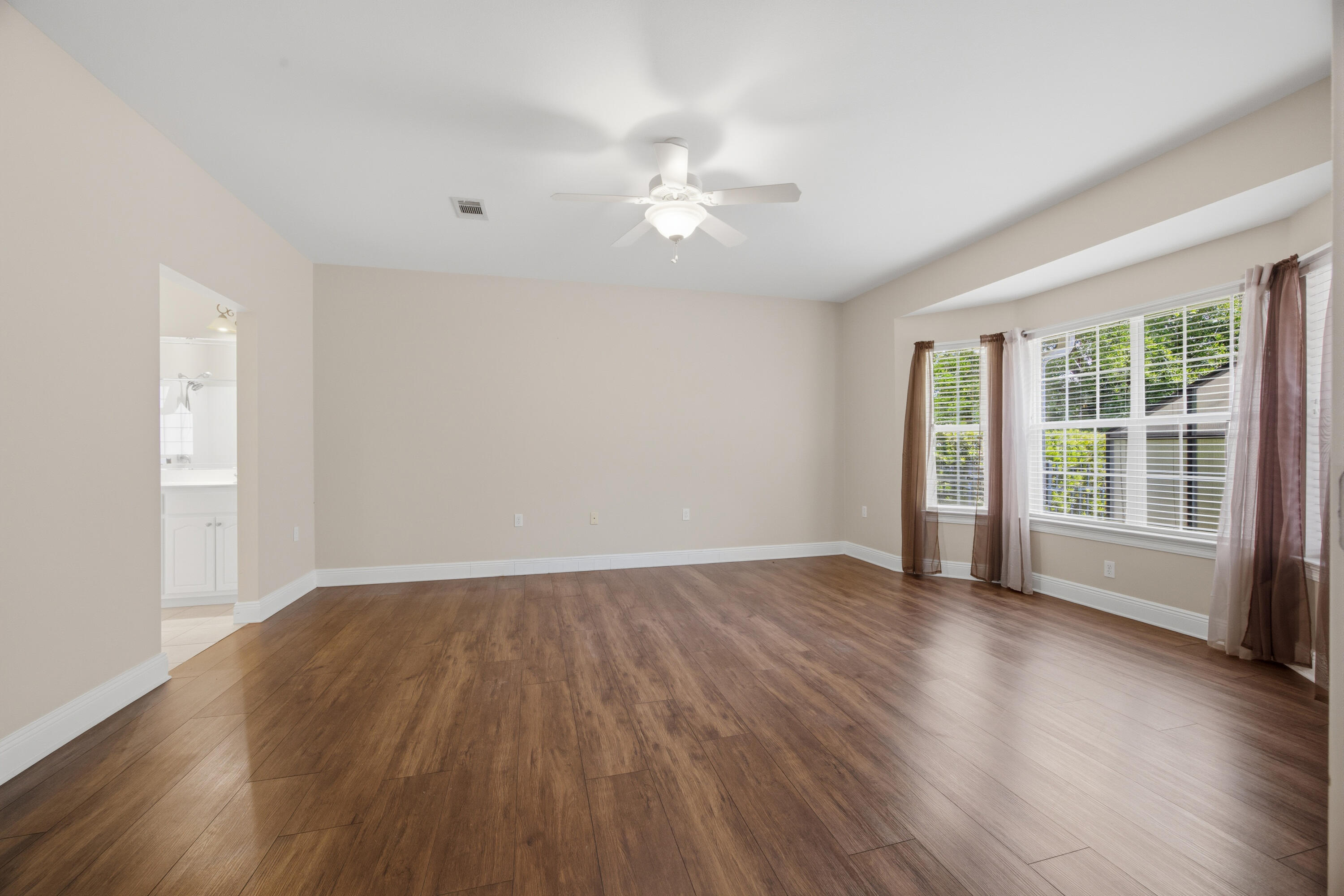 51 Tournament Lane Freeport, FL 32439 - Photo 35 of 71 a view of an empty room with wooden floor and a window