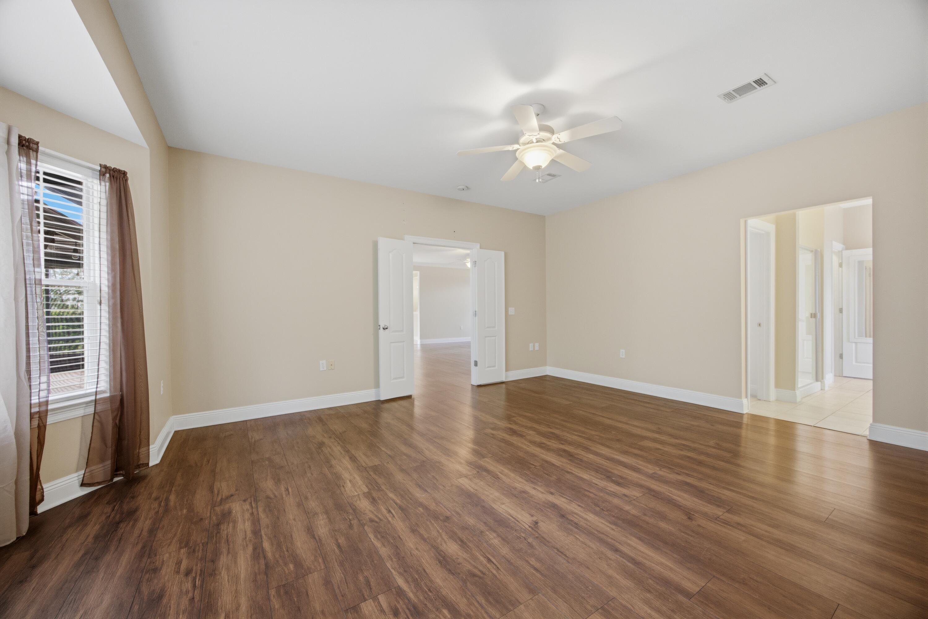 51 Tournament Lane Freeport, FL 32439 - Photo 36 of 71 an empty room with wooden floor and windows