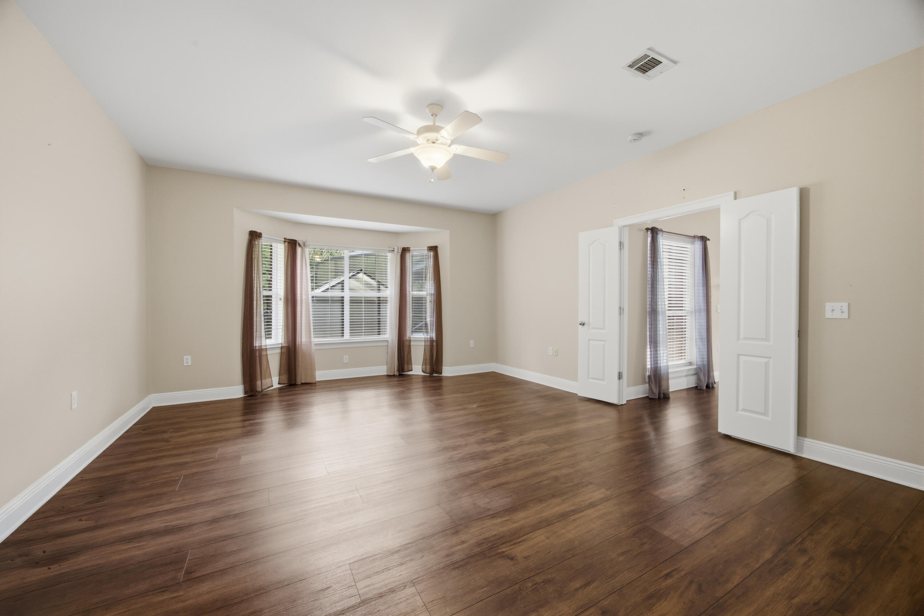 51 Tournament Lane Freeport, FL 32439 - Photo 37 of 71 a view of an empty room with wooden floor and a window