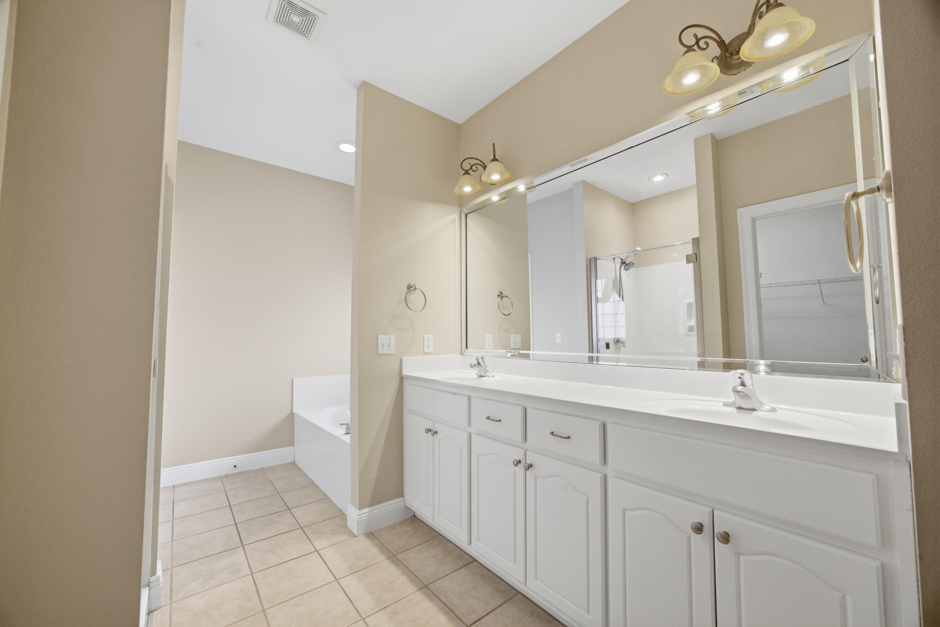 51 Tournament Lane Freeport, FL 32439 - Photo 38 of 71 a bathroom with a double vanity sink mirror and toilet