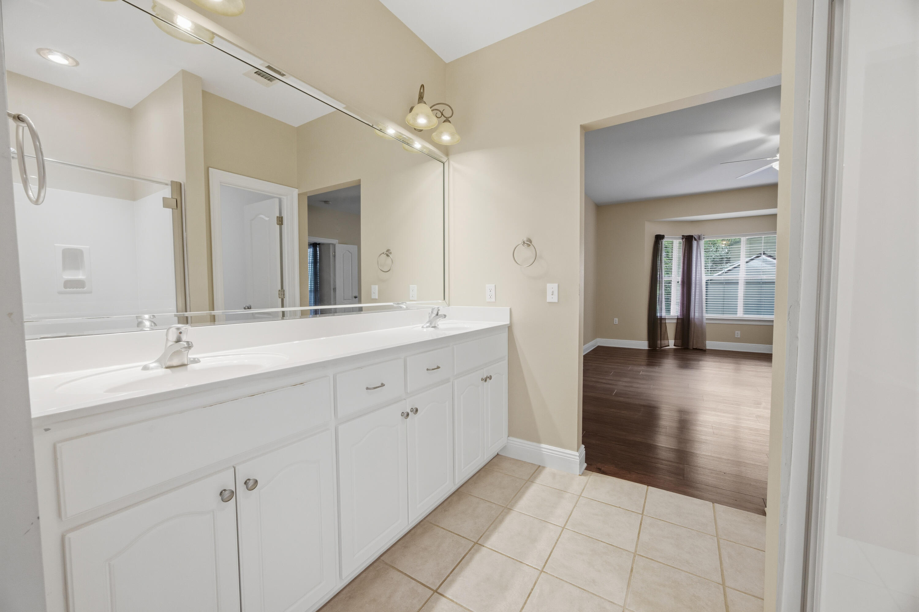 51 Tournament Lane Freeport, FL 32439 - Photo 40 of 71 a spacious en suite bathroom with a double vanity sink and mirror