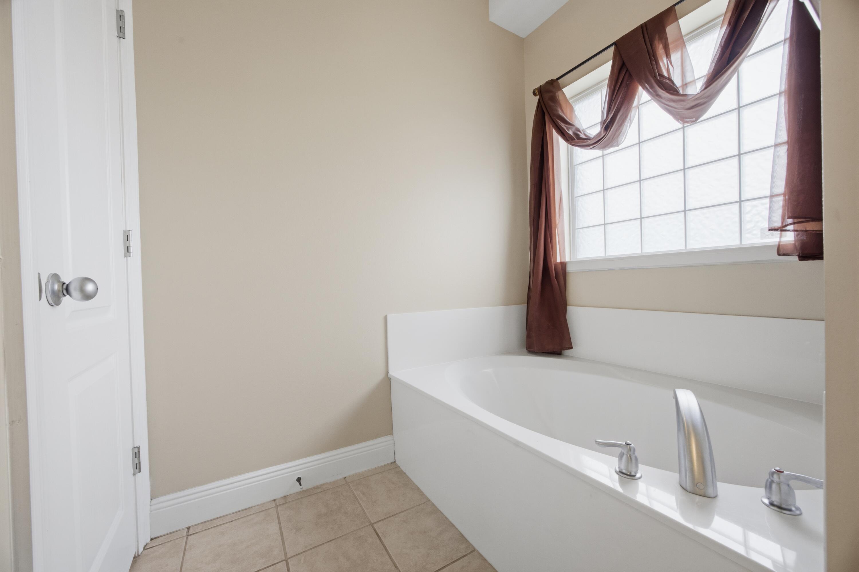 51 Tournament Lane Freeport, FL 32439 - Photo 42 of 71 a bathroom with a bathtub and a window