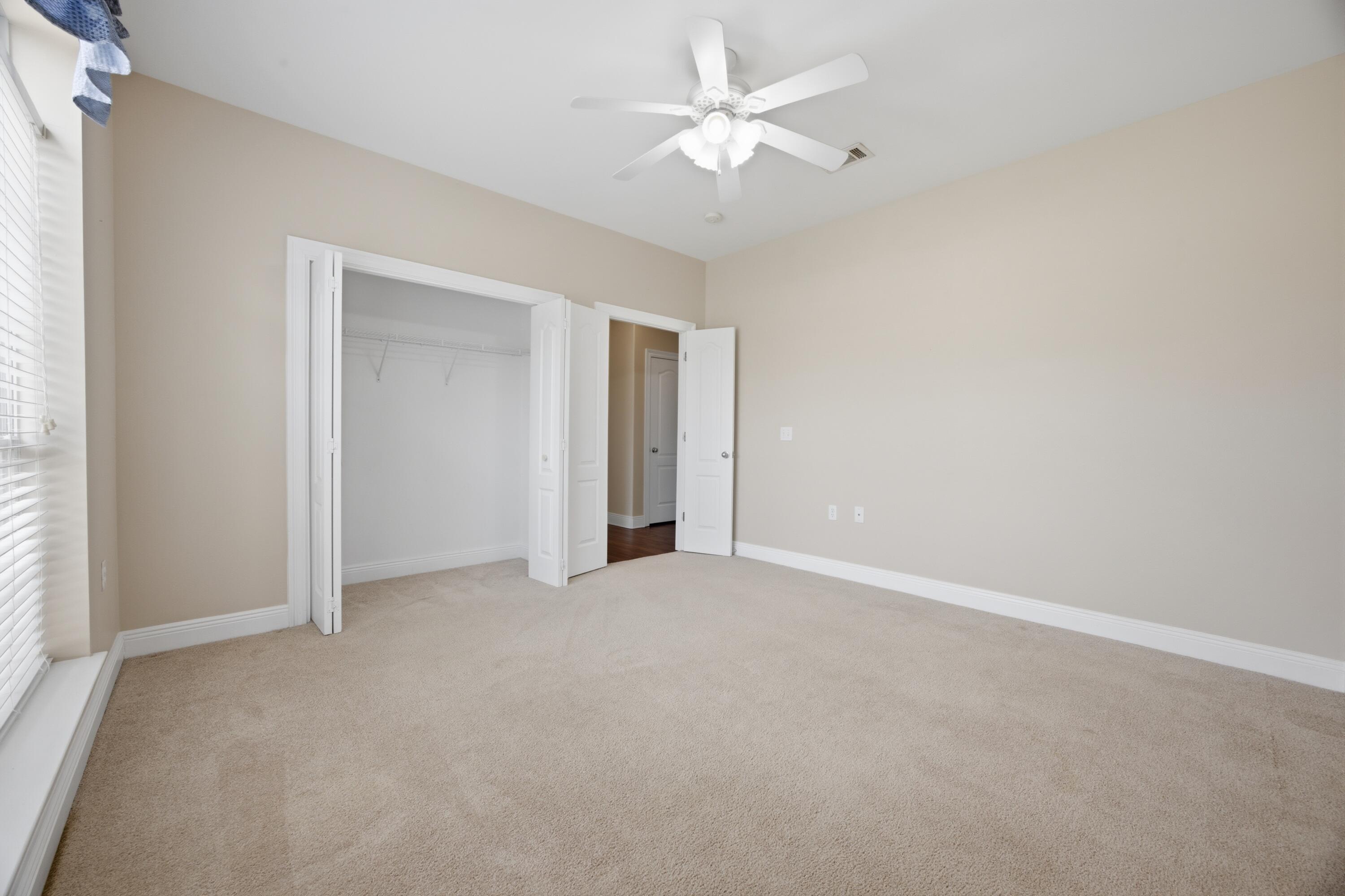 51 Tournament Lane Freeport, FL 32439 - Photo 50 of 71 an empty room with a ceiling fan and a window