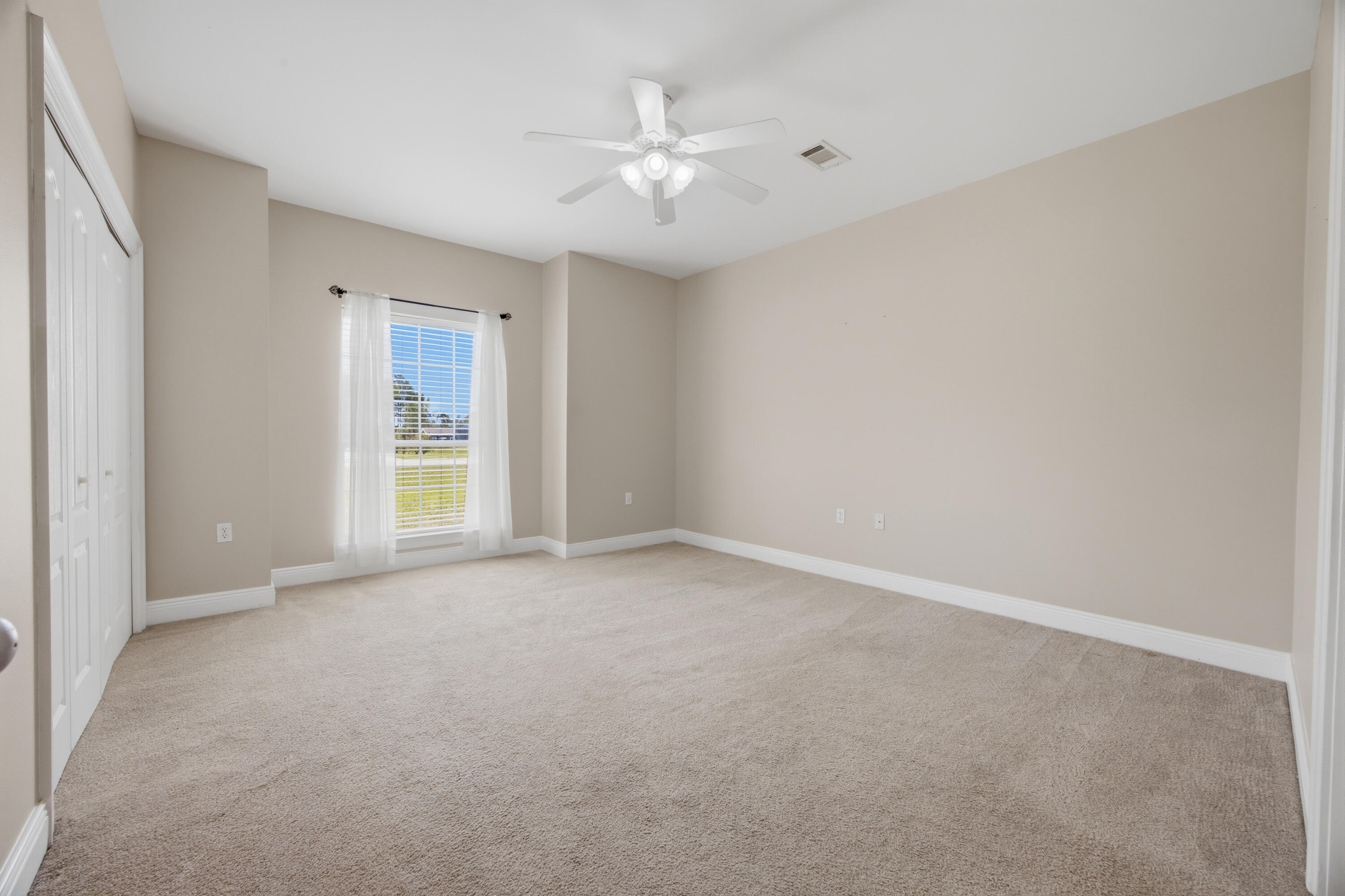 51 Tournament Lane Freeport, FL 32439 - Photo 51 of 71 an empty room with windows and ceiling fan