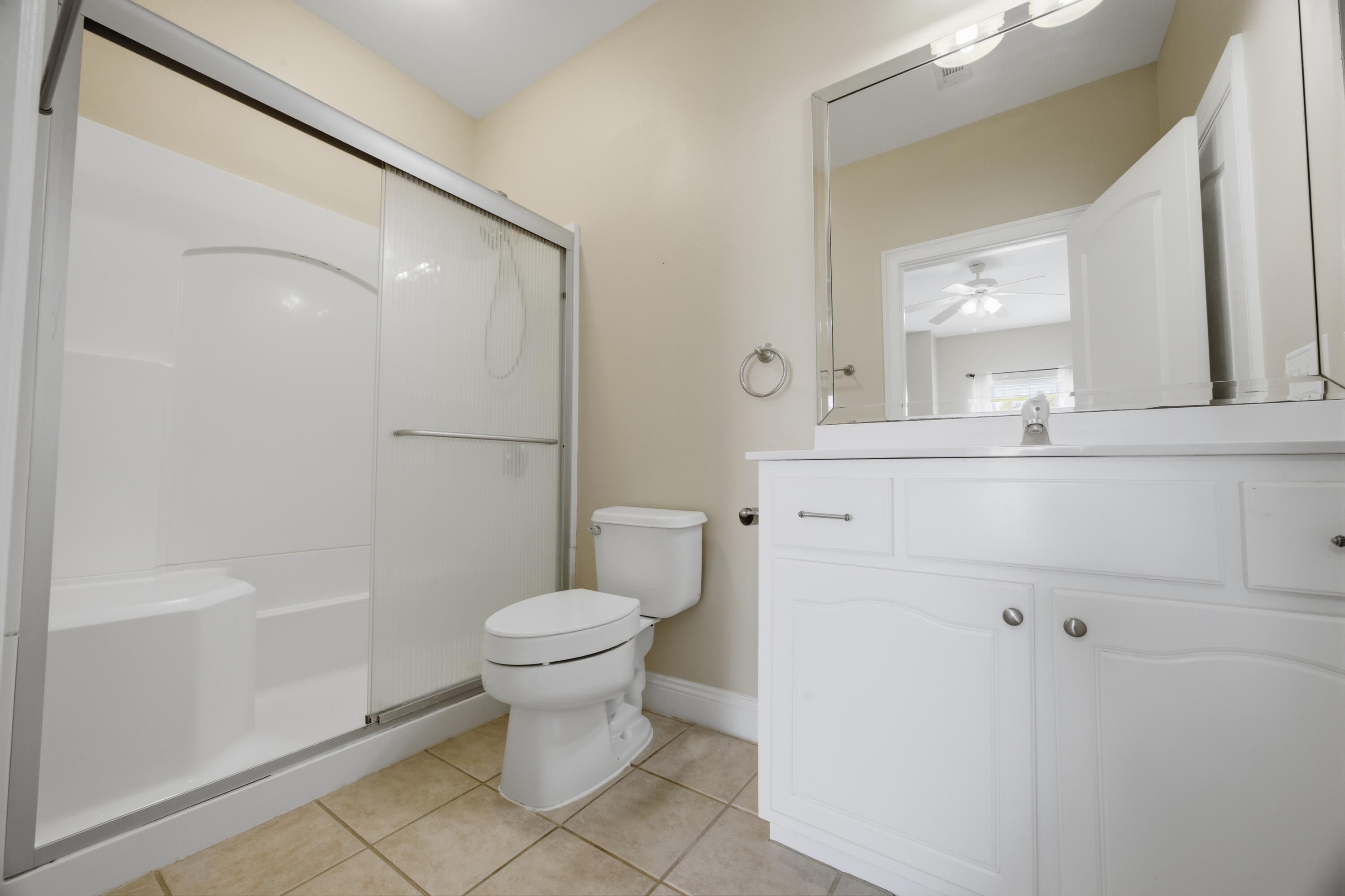 51 Tournament Lane Freeport, FL 32439 - Photo 54 of 71 a bathroom with a sink a toilet and a mirror
