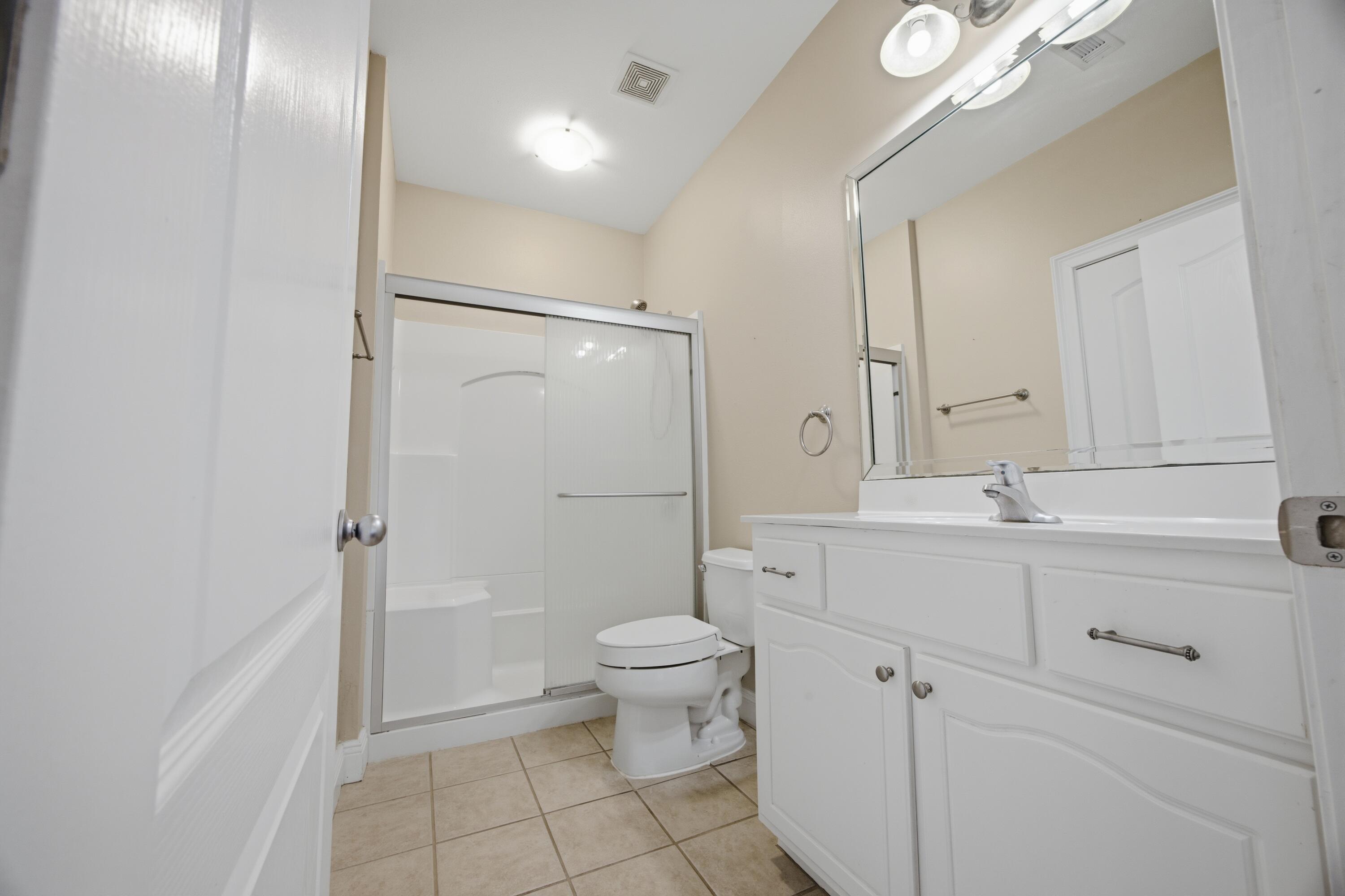 51 Tournament Lane Freeport, FL 32439 - Photo 57 of 71 a bathroom with a sink a toilet and shower