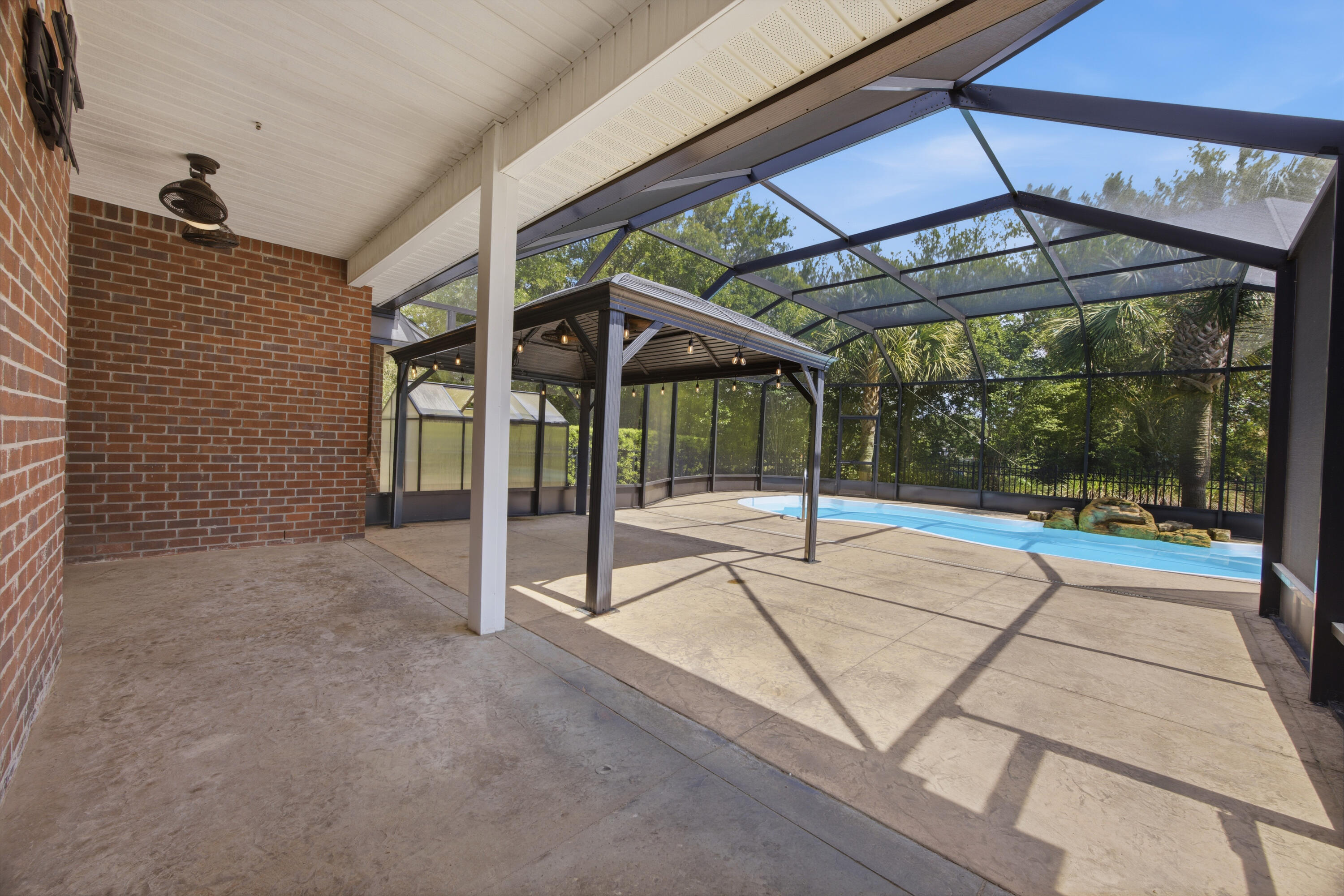 51 Tournament Lane Freeport, FL 32439 - Photo 60 of 71 a view of a patio with a table and chairs under an umbrella