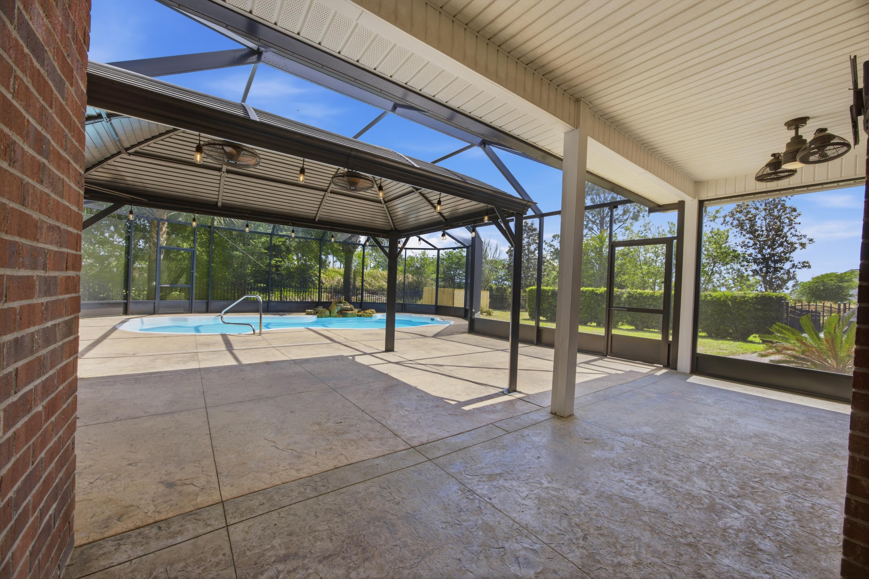 51 Tournament Lane Freeport, FL 32439 - Photo 61 of 71 a view of a swimming pool with a porch