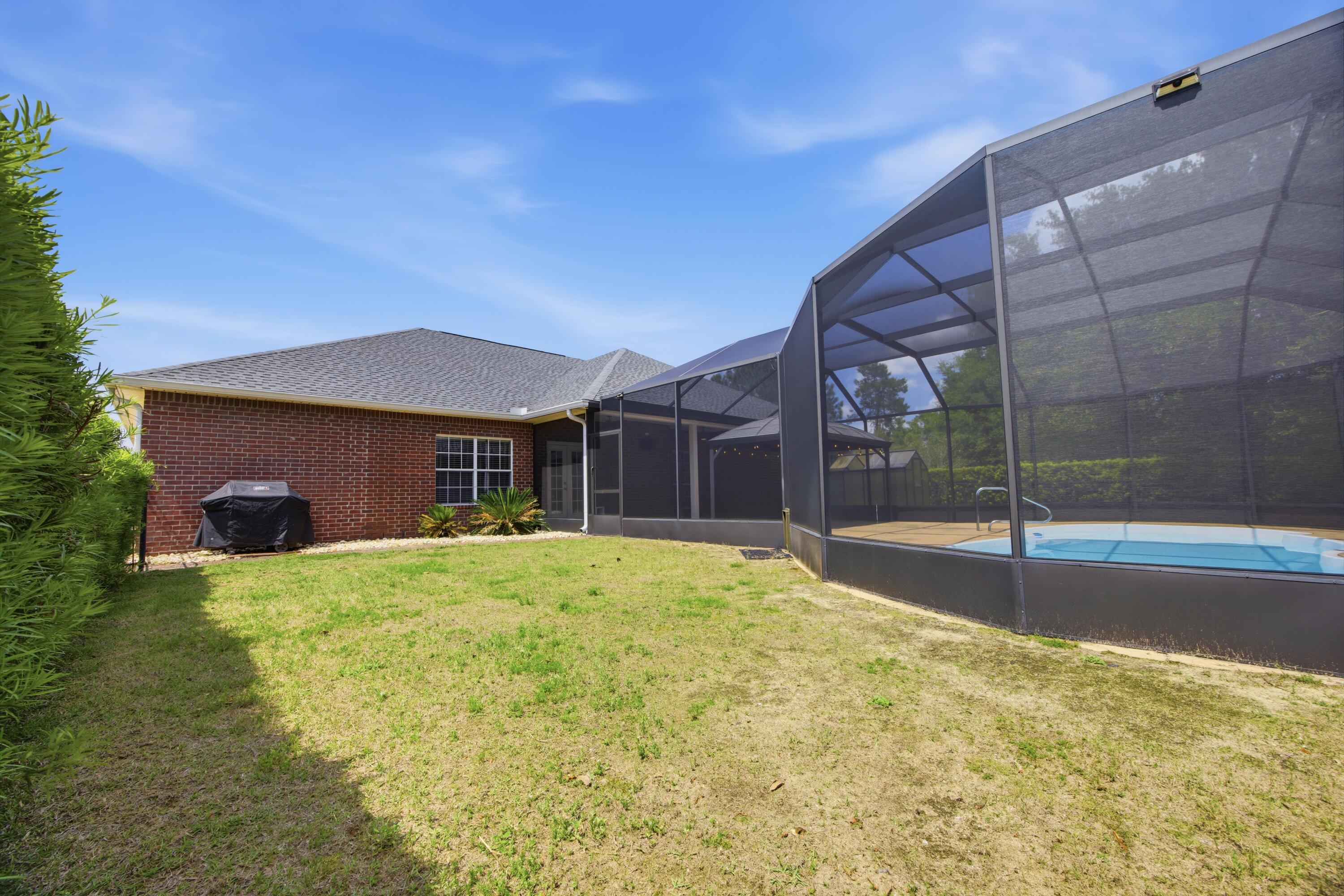 51 Tournament Lane Freeport, FL 32439 - Photo 63 of 71 a house view with swimming pool in front of it