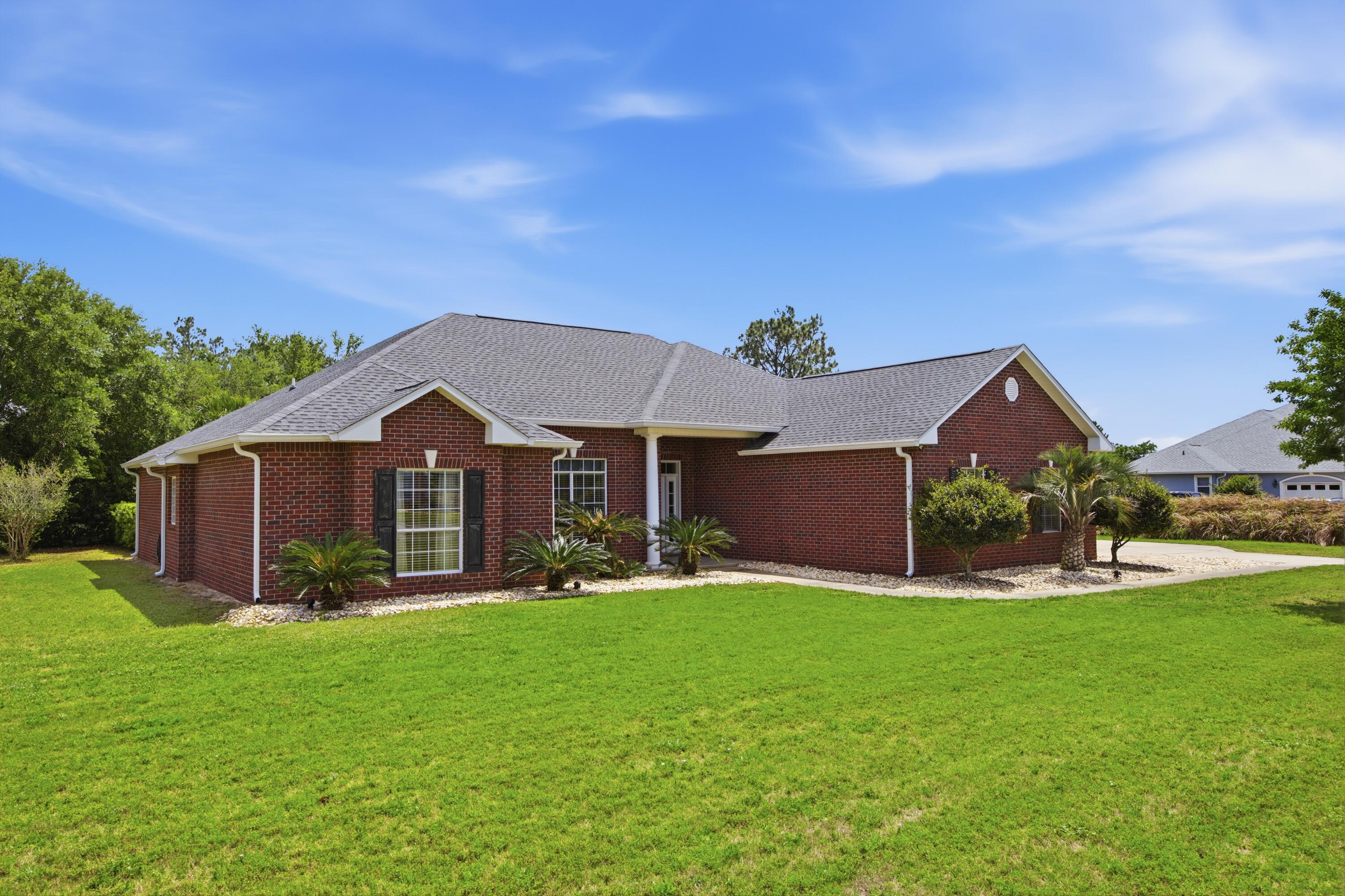 51 Tournament Lane Freeport, FL 32439 - Photo 10 of 71 a front view of house with yard and green space
