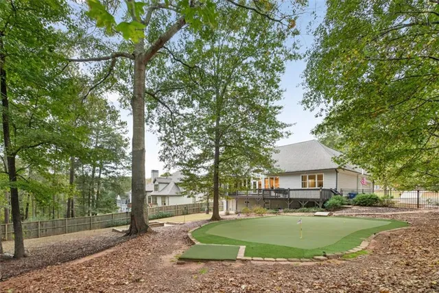 a front view of a house with a yard and tree
