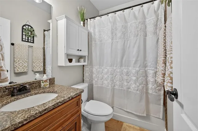 a living room with furniture a fireplace and a chandelier