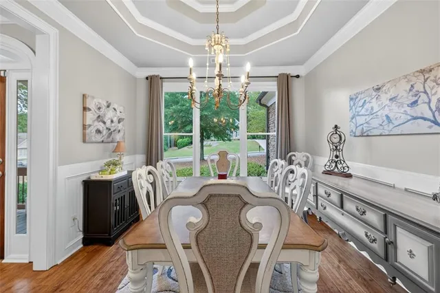 a living room with furniture kitchen view and a chandelier