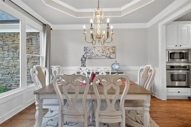a kitchen with cabinets appliances and a wooden floor