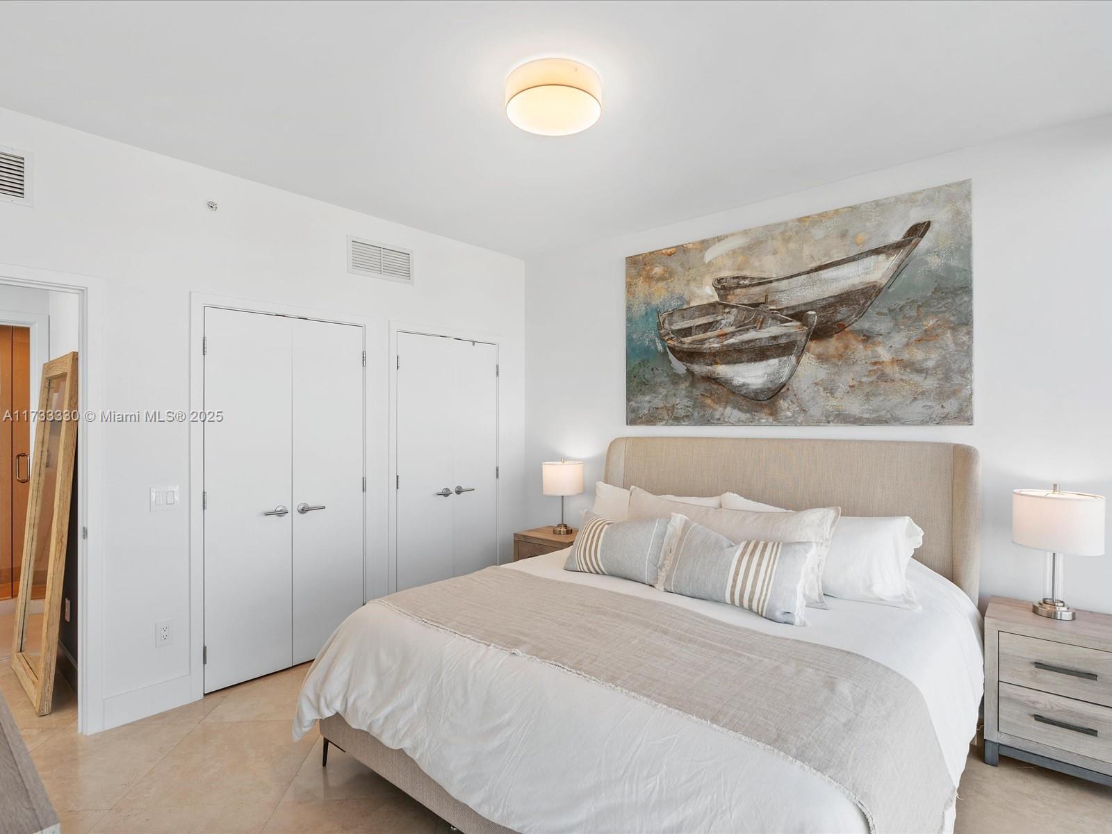6899 Collins Avenue, Unit 1704 Miami Beach, FL 33141 - Photo 17 of 25 a bedroom with a bed and a painting on the wall