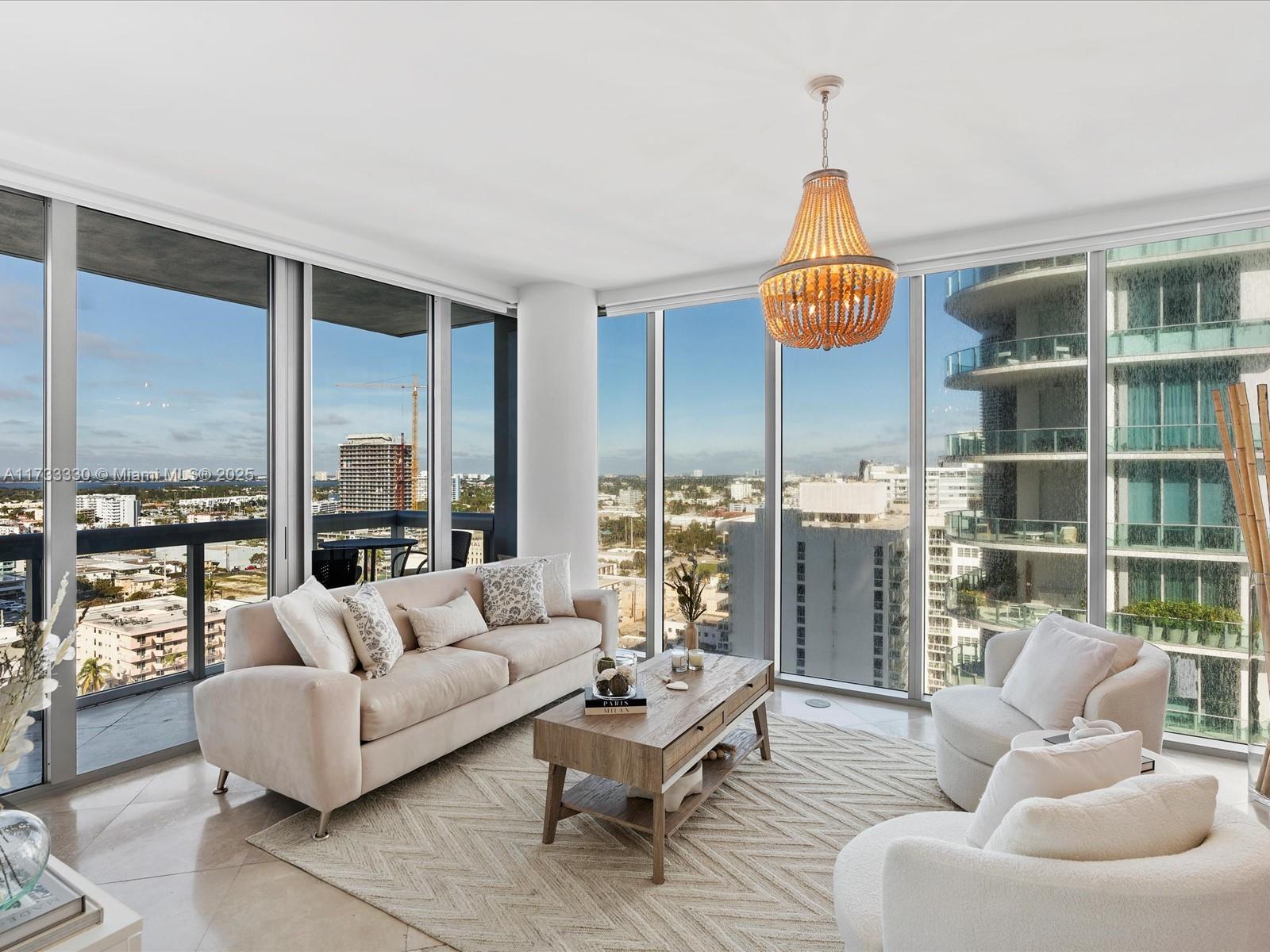 6899 Collins Avenue, Unit 1704 Miami Beach, FL 33141 - Photo 2 of 25 a living room with furniture and a large window