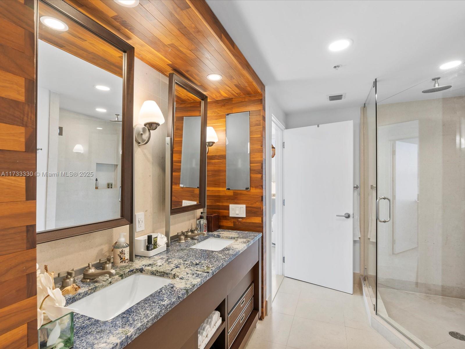 6899 Collins Avenue, Unit 1704 Miami Beach, FL 33141 - Photo 21 of 25 a bathroom with a granite countertop sink and a mirror