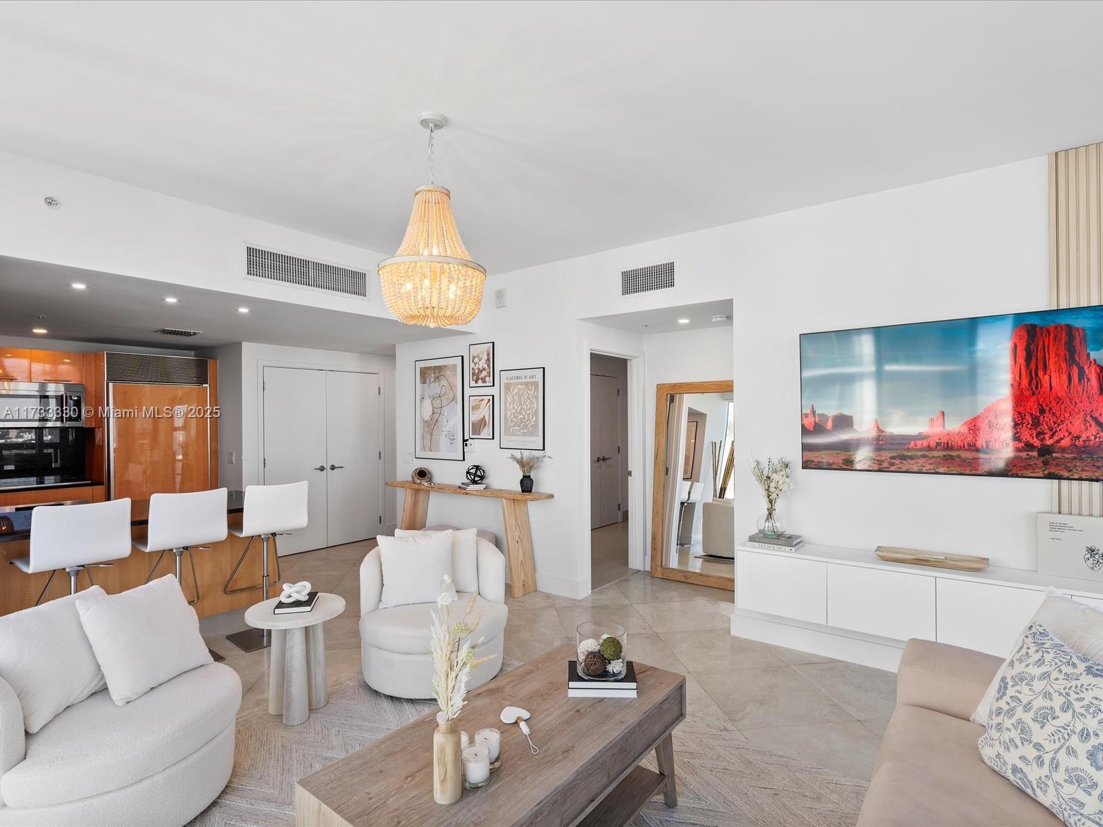 6899 Collins Avenue, Unit 1704 Miami Beach, FL 33141 - Photo 6 of 25 a living room with furniture and a large window