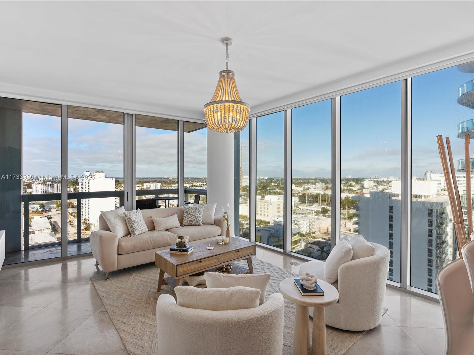 6899 Collins Avenue, Unit 1704 Miami Beach, FL 33141 - Photo 9 of 25 a living room with furniture and a large window