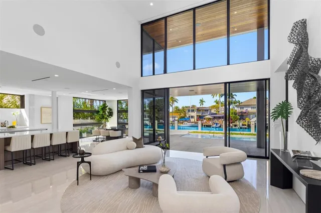 a living room with fireplace furniture and a large window