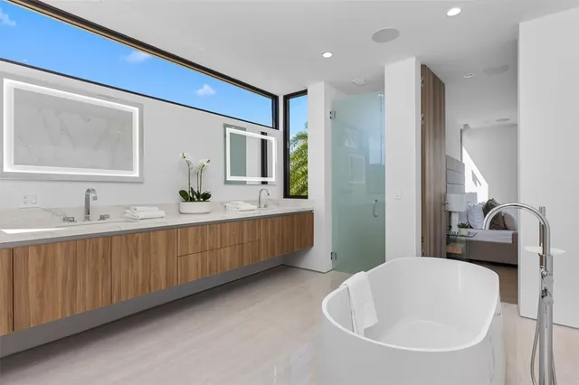 a bathroom with a shower and a glass door