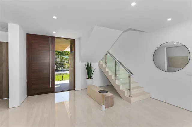 a dining room with stainless steel appliances a table and chairs