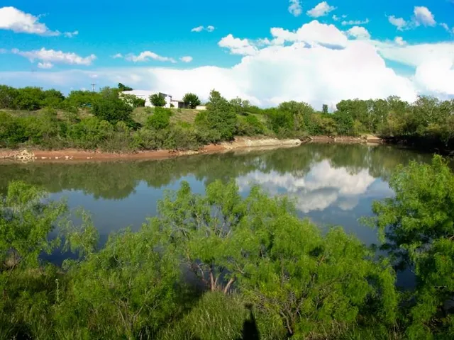 a view of a lake with a yard