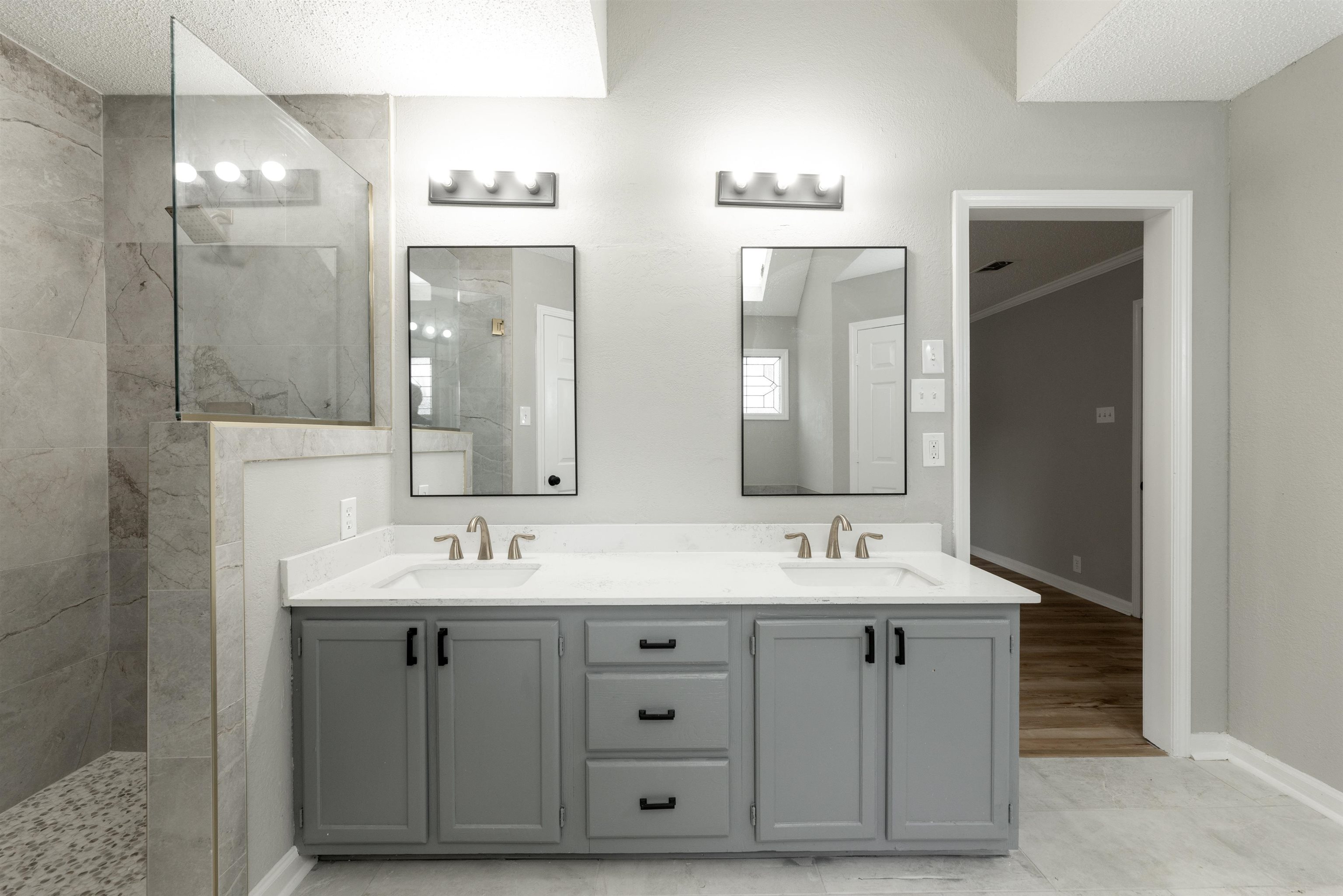 7421 Richmond Road Memphis, TN 38125 - Photo 24 of 39 Dual vanity with white countertops, grey cabinetry, and brushed nickel hardware