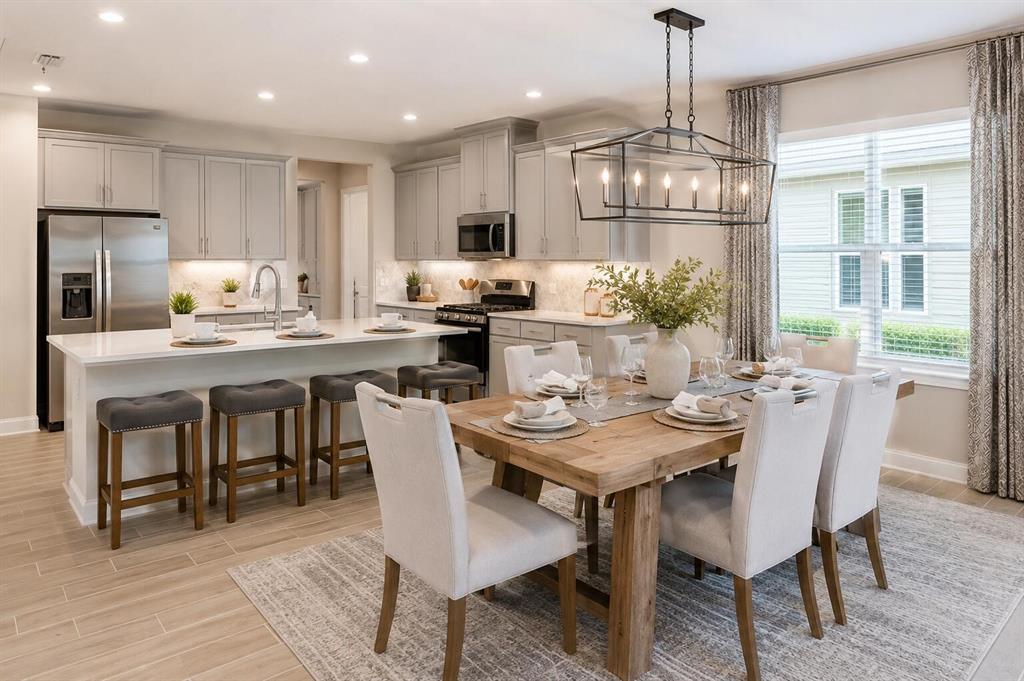 33320 Castaway Loop Wesley Chapel, FL 33543 - Photo 6 of 23 a view of a dining room with furniture a kitchen and chandelier