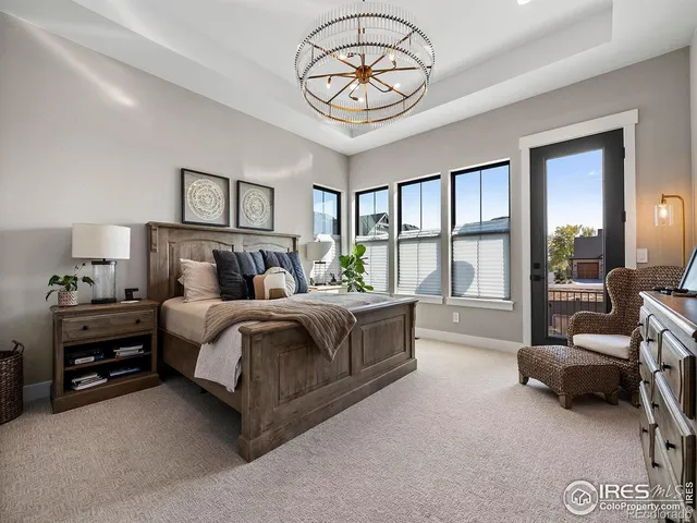 a en suite bathroom with a granite countertop sink a mirror and shower